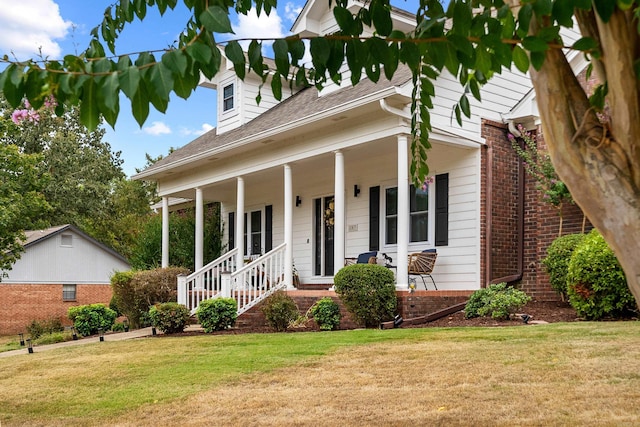 view of front of home with a porch and a front lawn