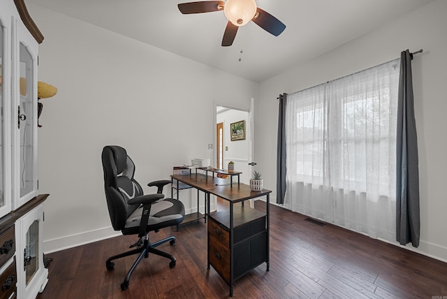 home office with dark wood-type flooring and ceiling fan