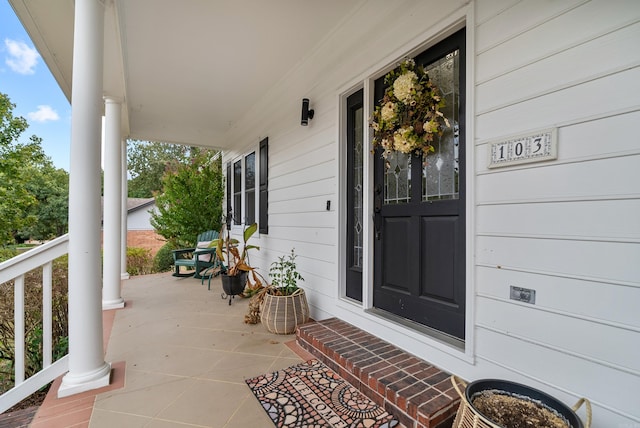 property entrance with covered porch