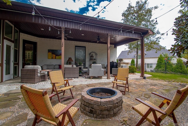 view of patio featuring an outdoor living space with a fire pit and ceiling fan