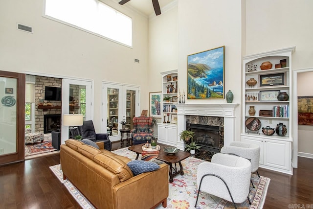 living room featuring ornamental molding, a healthy amount of sunlight, ceiling fan, and dark hardwood / wood-style floors