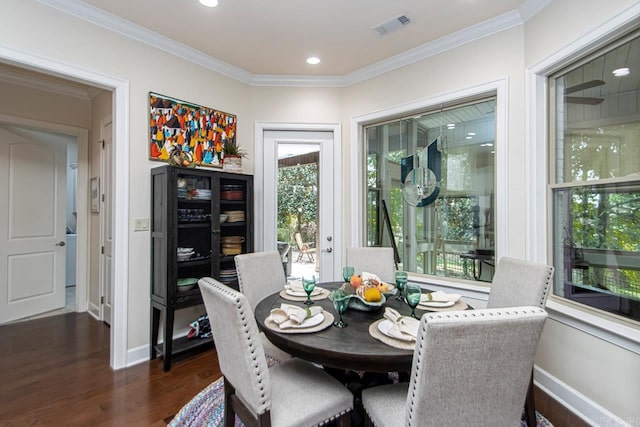 dining space featuring crown molding and dark wood-type flooring