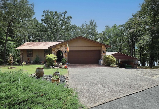 single story home featuring a garage, a front yard, and a carport