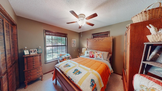 carpeted bedroom featuring a textured ceiling, a closet, and ceiling fan