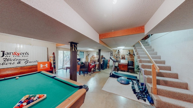 recreation room with concrete flooring, a textured ceiling, and pool table