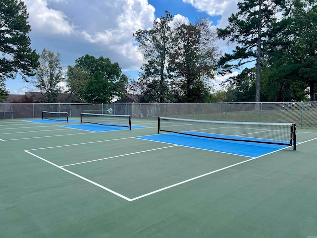 view of tennis court featuring basketball hoop