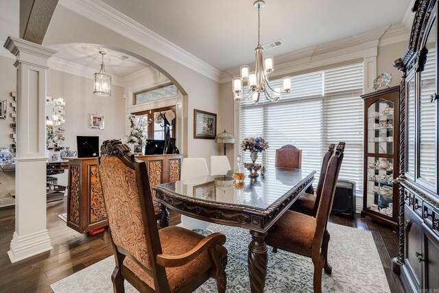 dining area featuring dark hardwood / wood-style flooring, a healthy amount of sunlight, and ornate columns