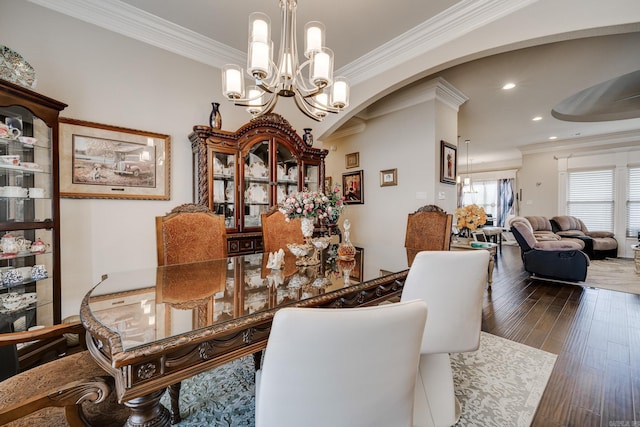 dining room with ornamental molding, dark hardwood / wood-style floors, and a chandelier