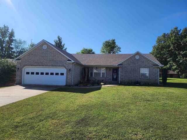 single story home featuring a garage and a front yard