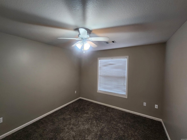 carpeted spare room featuring a textured ceiling and ceiling fan