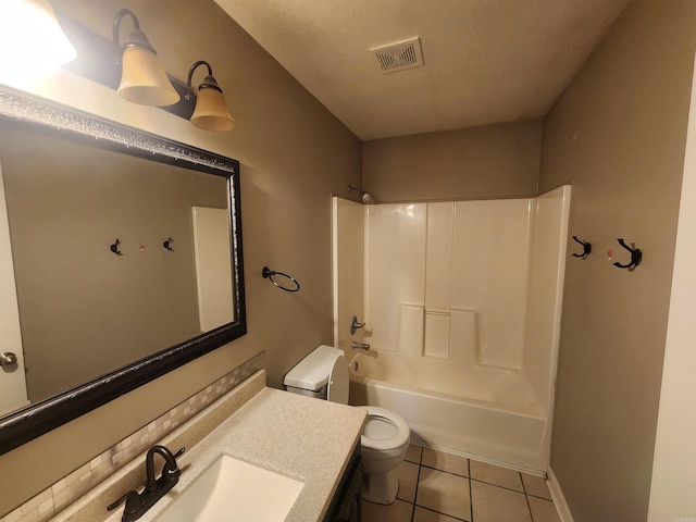 full bathroom featuring tile patterned flooring, tub / shower combination, a textured ceiling, vanity, and toilet