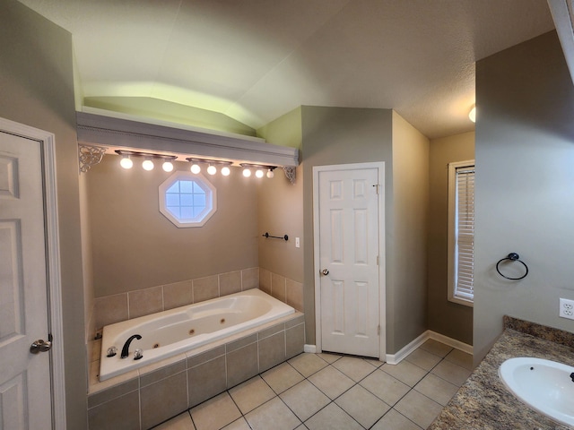 bathroom featuring vanity, vaulted ceiling, tile patterned flooring, and tiled tub