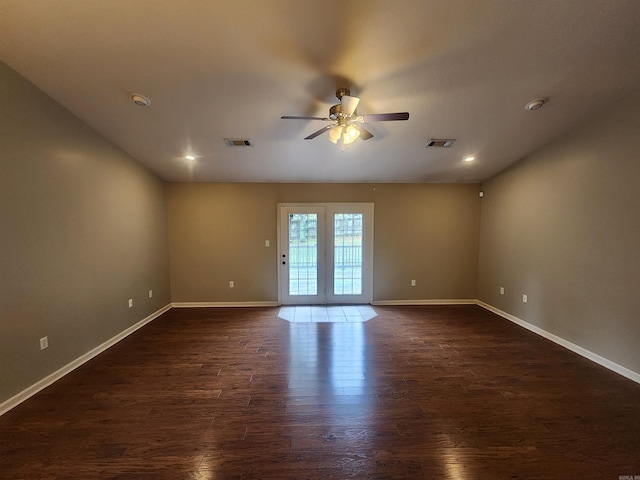 empty room featuring dark wood-type flooring and ceiling fan