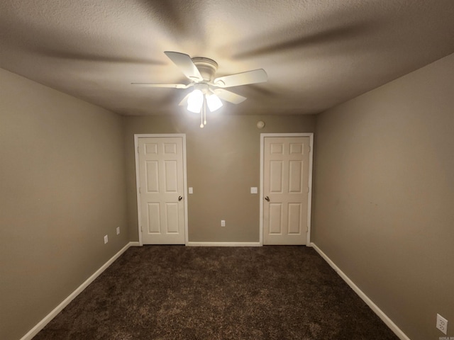 carpeted empty room with ceiling fan and a textured ceiling