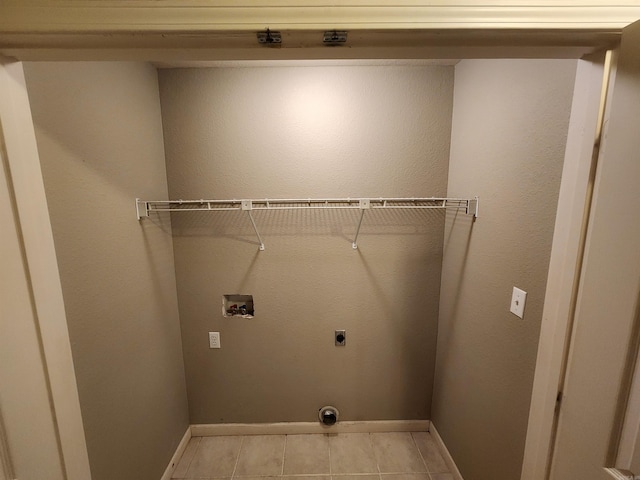 laundry room with washer hookup, light tile patterned floors, and hookup for an electric dryer