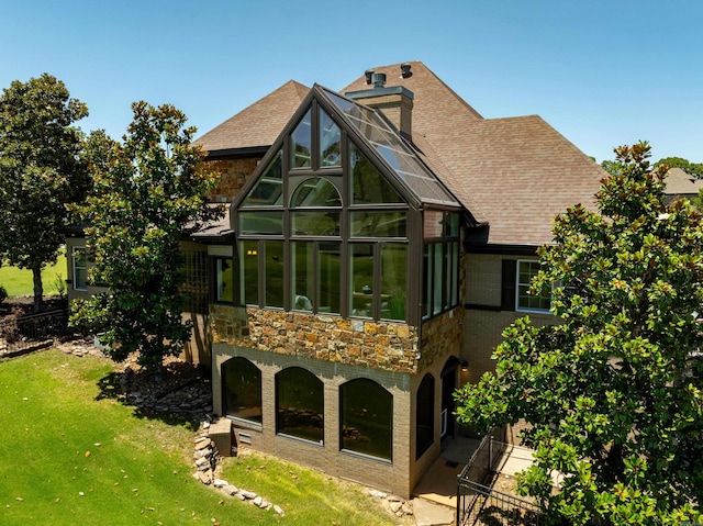 rear view of property featuring a yard