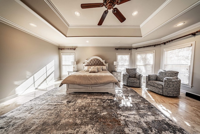 bedroom with ceiling fan, ornamental molding, a tray ceiling, and multiple windows