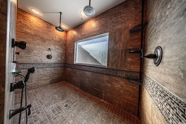 bathroom featuring a shower and tile walls