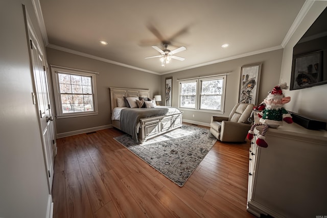 bedroom featuring ornamental molding, hardwood / wood-style floors, and ceiling fan