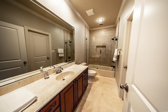 full bathroom with vanity, tile patterned flooring, toilet, ornamental molding, and tiled shower / bath