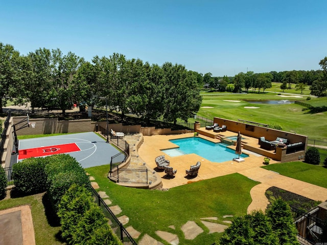 view of pool featuring a lawn, an outdoor living space, basketball hoop, and a patio