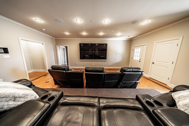 home theater featuring ornamental molding and light hardwood / wood-style floors