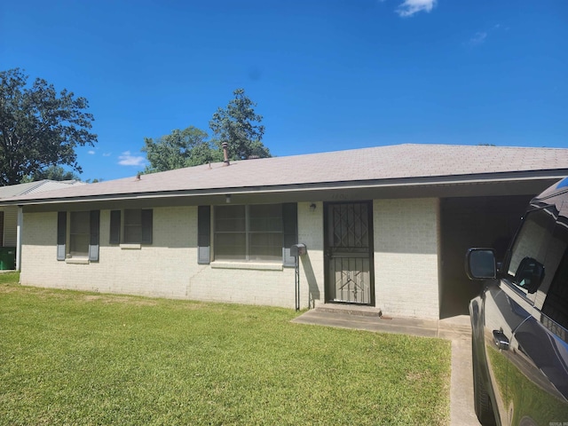 rear view of property featuring a yard