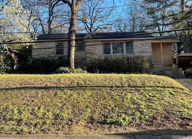 ranch-style house with stone siding