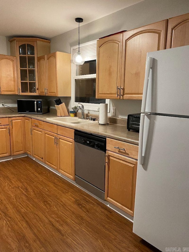 kitchen featuring dark hardwood / wood-style floors, white fridge, dishwasher, hanging light fixtures, and sink