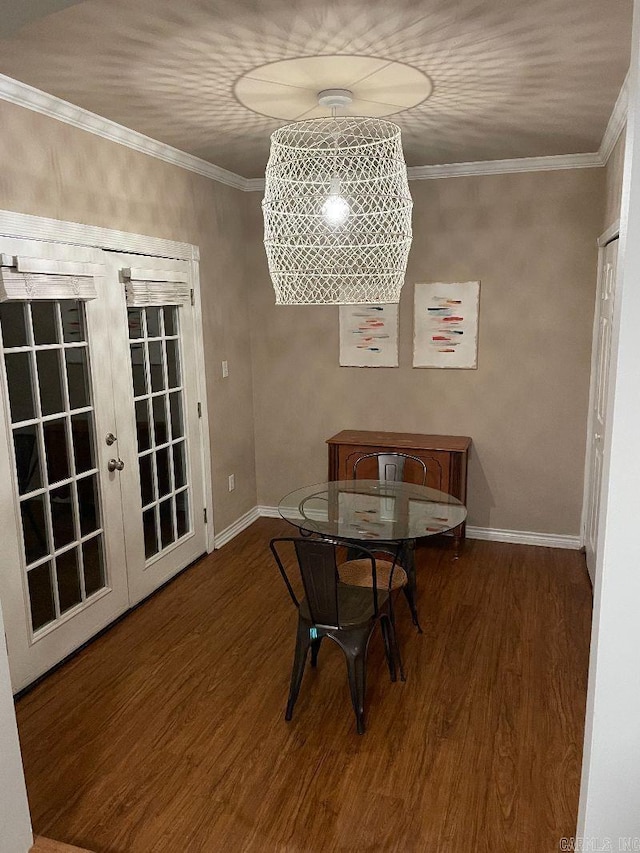 dining space with crown molding, dark wood-type flooring, and french doors