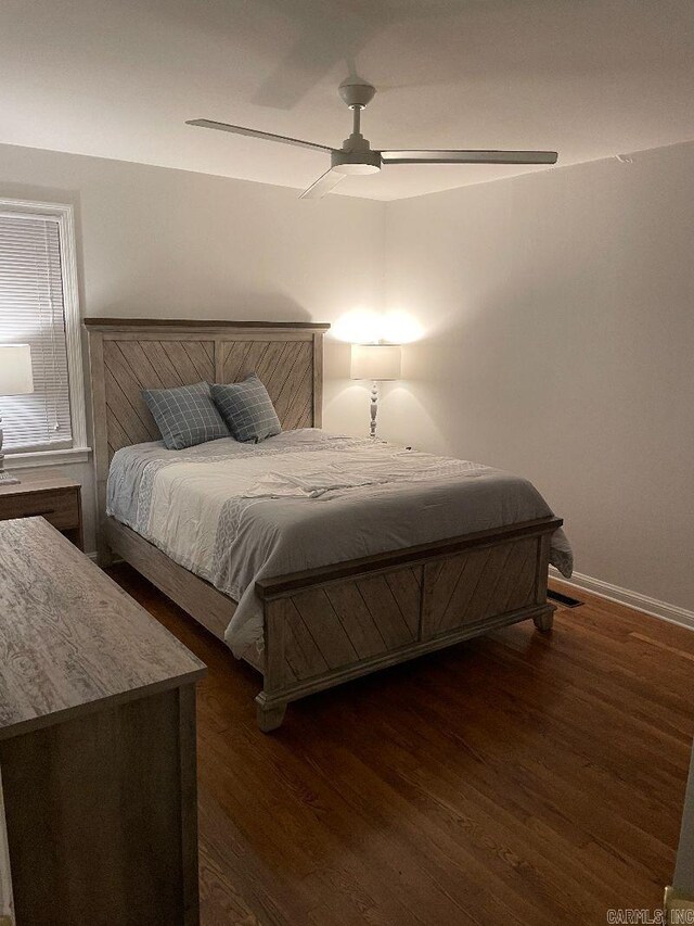 bedroom with ceiling fan and dark hardwood / wood-style flooring