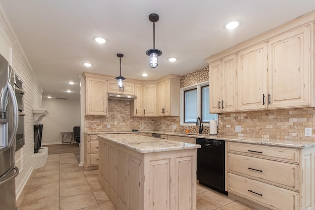 kitchen with a fireplace, decorative light fixtures, black appliances, a kitchen island, and light stone countertops