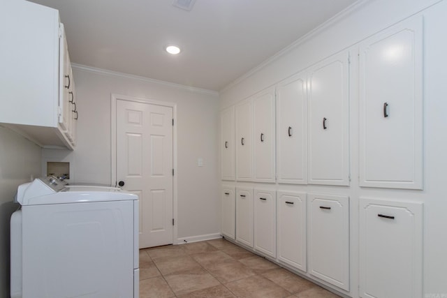 clothes washing area with washer and clothes dryer, light tile patterned floors, crown molding, and cabinets