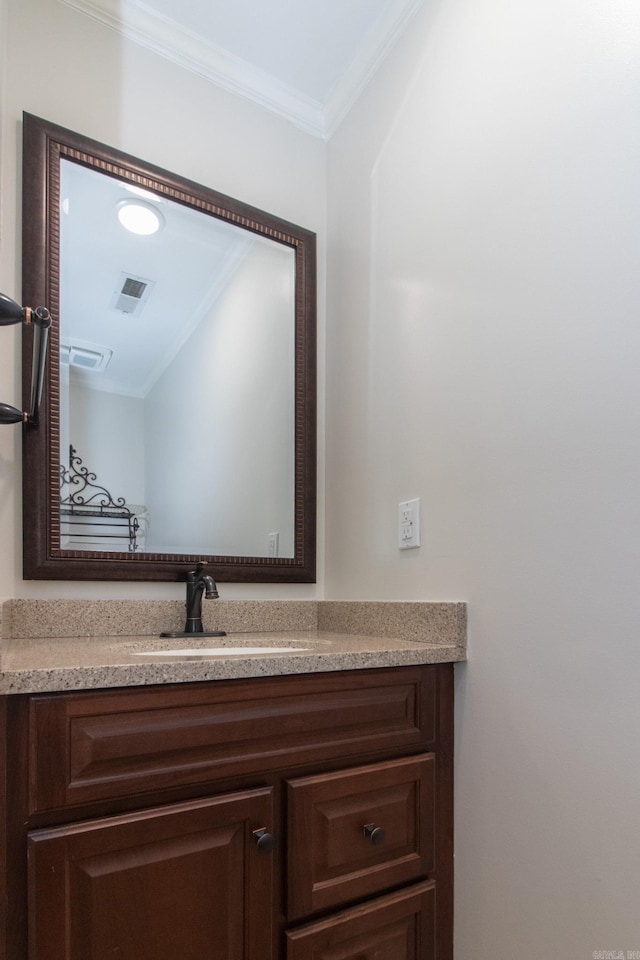 bathroom with crown molding and vanity