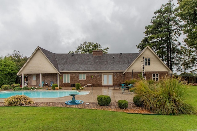 back of property featuring a yard and a patio area