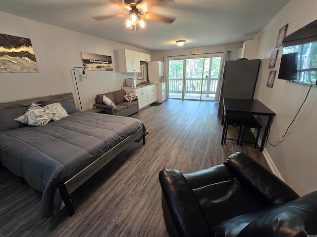 living room with ceiling fan, hardwood / wood-style flooring, and sink