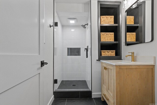 bathroom with vanity, a shower with shower door, and tile patterned flooring