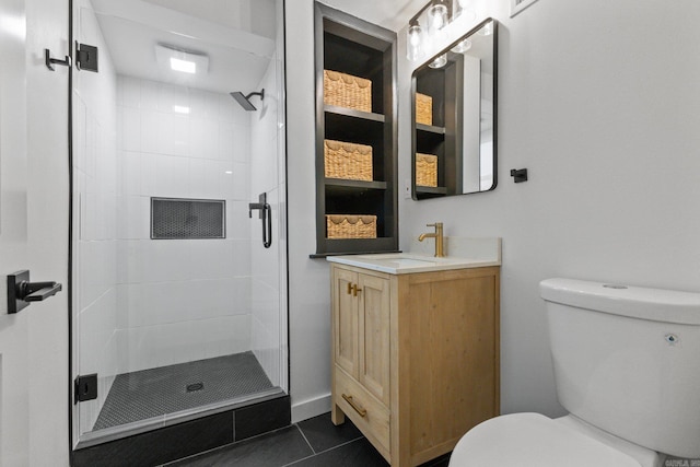 bathroom featuring vanity, toilet, tile patterned floors, and a shower with shower door