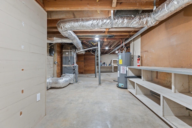 basement with electric water heater and heating unit