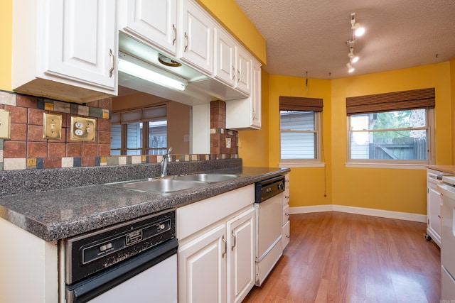 kitchen featuring light wood-type flooring, white cabinetry, a textured ceiling, dishwasher, and sink