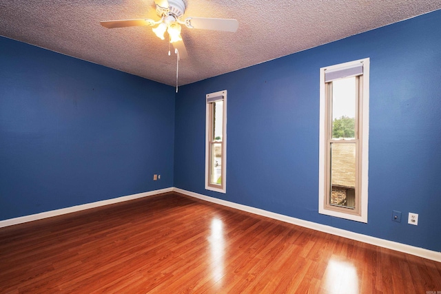 unfurnished room featuring ceiling fan, wood-type flooring, and a textured ceiling