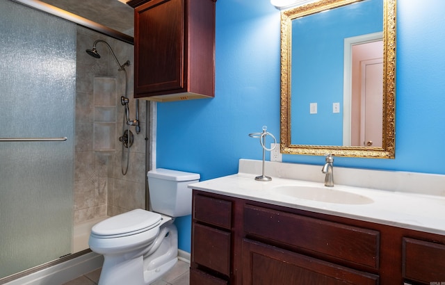 bathroom featuring vanity, toilet, tile patterned flooring, and a shower with door