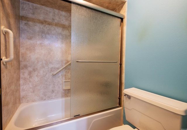 bathroom featuring toilet and enclosed tub / shower combo