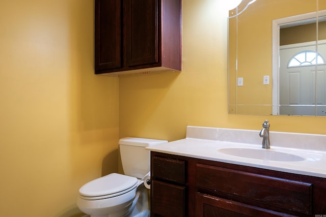 bathroom featuring toilet and vanity