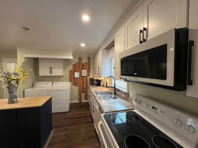 kitchen featuring white range oven, white cabinetry, washer and clothes dryer, and sink