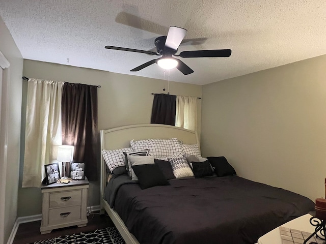 bedroom with a textured ceiling and ceiling fan