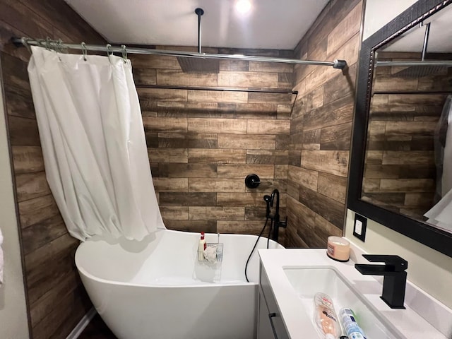 bathroom featuring wood walls, shower / bath combination with curtain, and vanity