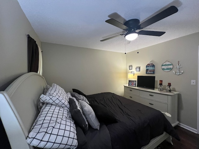 bedroom featuring a textured ceiling, dark hardwood / wood-style flooring, and ceiling fan