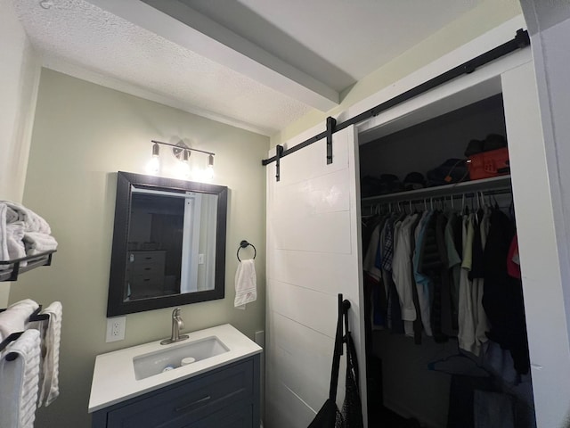 bathroom with a textured ceiling and vanity