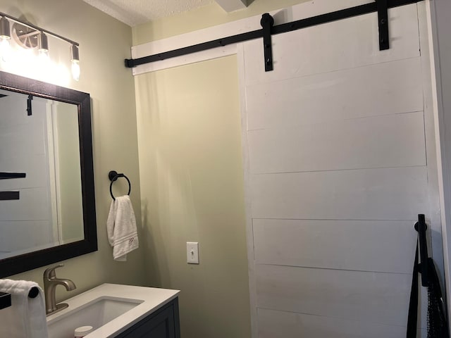 bathroom with vanity and a textured ceiling